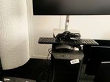 a desk with a computer, keyboard, and monitor on it