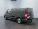 a picture of a black van parked in a large room