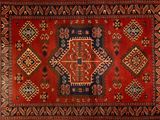 a close up of a rug with a red and blue design on it