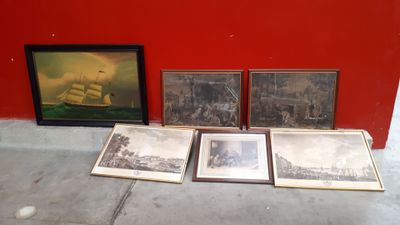 three framed pictures of a ship and a ship in a red room