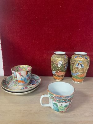 three cups and a saucer sitting on a table