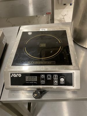 a stove top that is sitting on a table in a kitchen