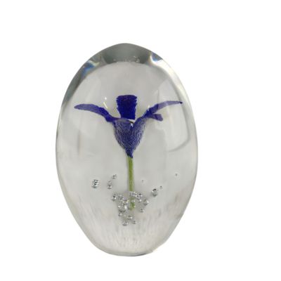a glass object with a flower inside of it