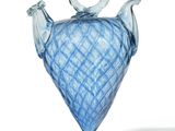 a blue glass vase with a handle on a white background