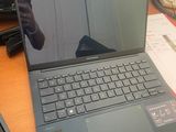 a laptop that is sitting on a desk in front of a computer monitor