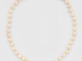 un collier en perles et en or orné d'un pendentif en citrine