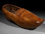 an old wooden shoe that is sitting on top of a table