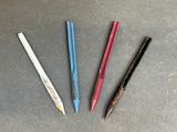 three different colored pencils sitting next to each other on a table