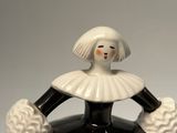a ceramic figurine of a woman in a blue dress