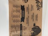 a brown paper bag with a black cat sitting on top of it