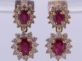 a pair of ruby and diamond earrings
