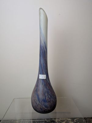 a blue and white vase sitting on a glass table