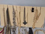 many different necklaces and bracelets displayed on the table