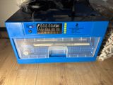 a blue box with a digital clock on top of it