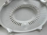 a white plate with holes in the middle of it