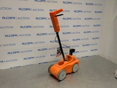 a small orange machine that is sitting on the floor