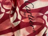 pink and white camouflage print shirt with a black logo on the chest