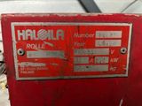 a close up of a red machine in a warehouse