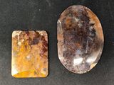 two different types of stone on a black surface