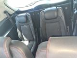 two seats in the back of a car that are dirty