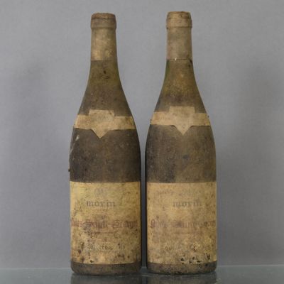 two bottles of wine sitting on top of a table next to each other