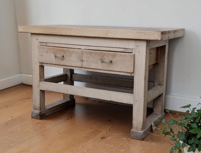a small wooden table with two drawers on top of it