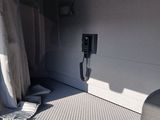 an image of the inside of a van with a phone on the bed