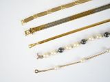 five different types of bracelets on a white surface