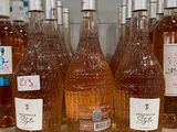 bottles of wine are lined up on a shelf in a store