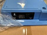a blue machine that is sitting on top of a box