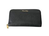 a black leather wallet with a gold logo on the front