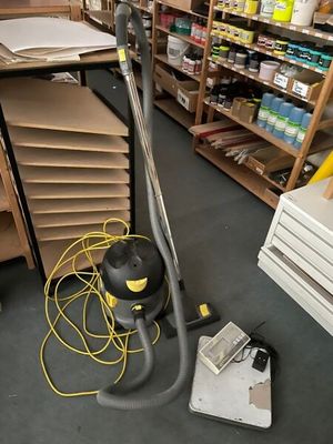 a vacuum that is sitting on the floor in a room