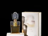 an image of a bottle of perfume sitting on a table next to a box