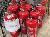 fire extinguisors are lined up in a row on the sidewalk