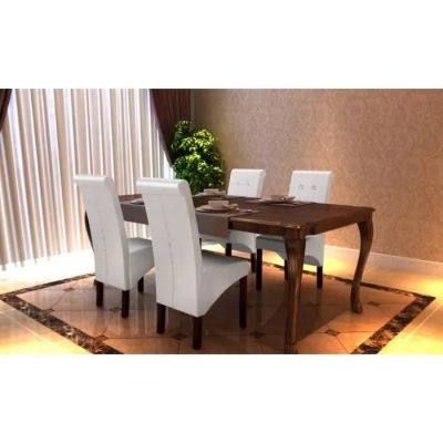 a dining room table with white chairs and a potted plant in the corner
