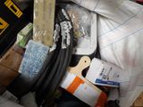 a pile of assorted items in a bin on the floor