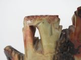 a close up of a vase with a bird on it
