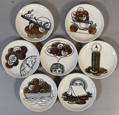 six plates with different designs on them sitting on a table