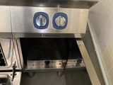 a stainless steel stove with two burners in a kitchen