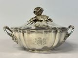 an antique silverplated sugar dish with a lid and handles