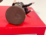 a small figurine sitting on top of a red box
