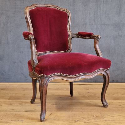 an image of a red chair sitting on top of a hard wood floor