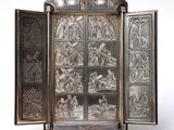 an image of a silver case with a picture of a scene inside of it