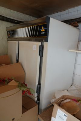 a refrigerator and boxes in a room with a lot of boxes on the floor