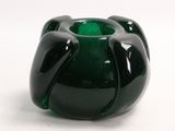 a green vase that is sitting on a white surface