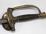 a close up of a sword on a white surface
