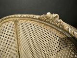 an old fashioned chair with a gold finish and a black background