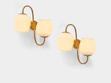 pair of gold plated wall sconces with white glass shades