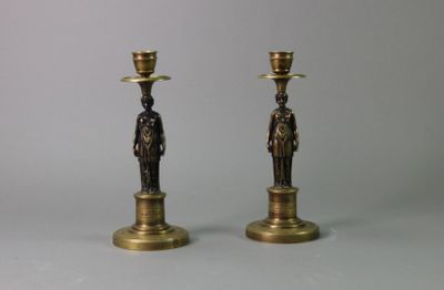 pair of antique brass candlesticks with figures on each of them