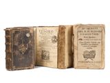 two old books sitting on top of each other on a white surface